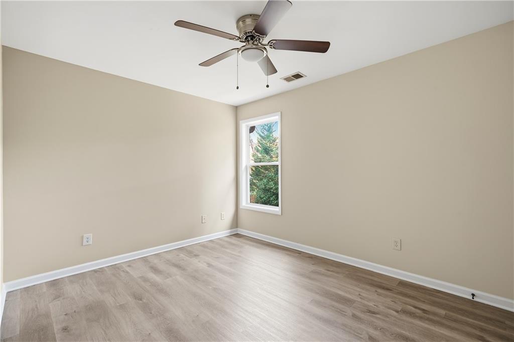 404 Sheila Way Canton, GA 30114 - Photo 23 of 36 an empty room with a window and a fan