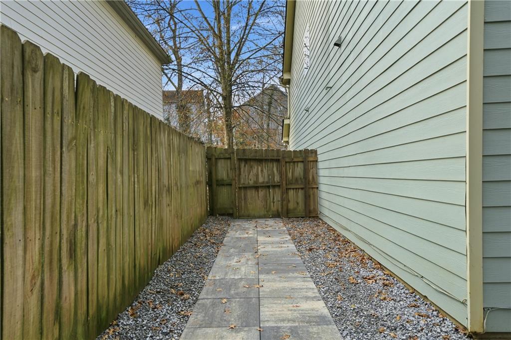 404 Sheila Way Canton, GA 30114 - Photo 27 of 36 a view of a pathway gate with wooden fence