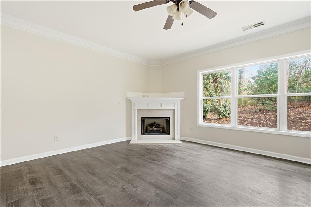 404 Sheila Way Canton, GA 30114 - Photo 3 of 36 an empty room with chandelier fan and windows