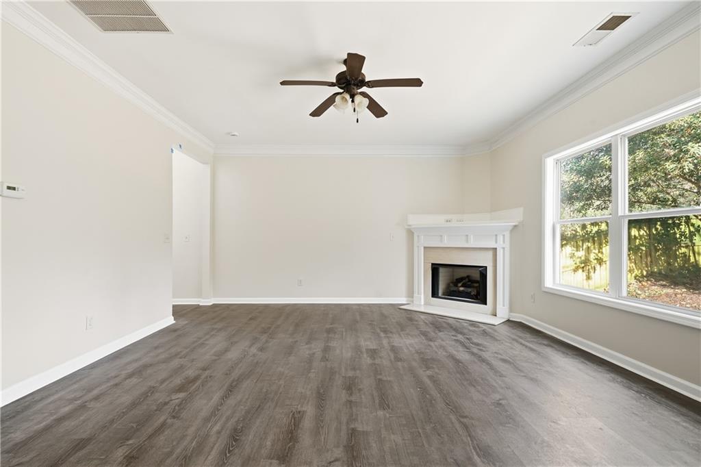 404 Sheila Way Canton, GA 30114 - Photo 5 of 36 a view of an empty room with wooden floor fireplace and a window