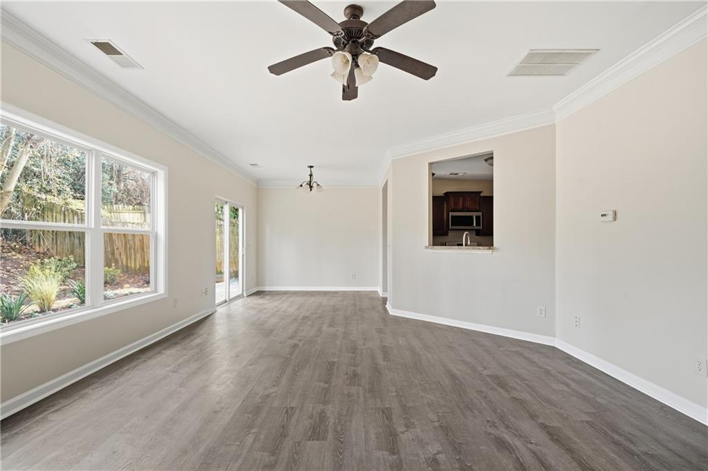 404 Sheila Way Canton, GA 30114 - Photo 6 of 36 a view of an empty room with a window and wooden floor