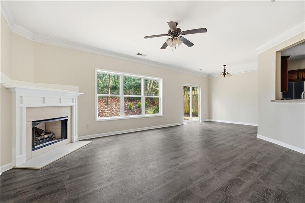 404 Sheila Way Canton, GA 30114 - Photo 7 of 36 a view of an empty room with wooden floor fireplace and a window