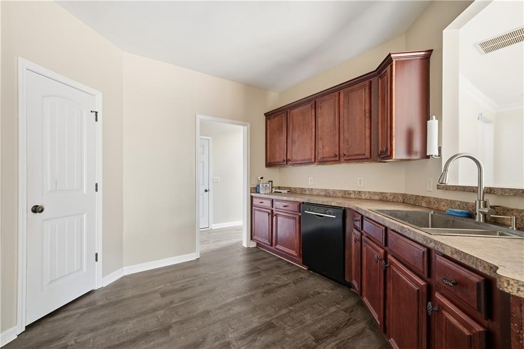 404 Sheila Way Canton, GA 30114 - Photo 9 of 36 a kitchen with stainless steel appliances granite countertop a sink stove and cabinets