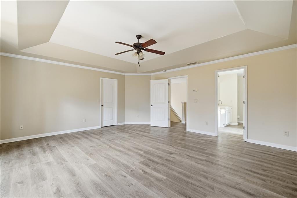 404 Sheila Way Canton, GA 30114 - Photo 10 of 36 a view of an empty room with wooden floor and a ceiling fan