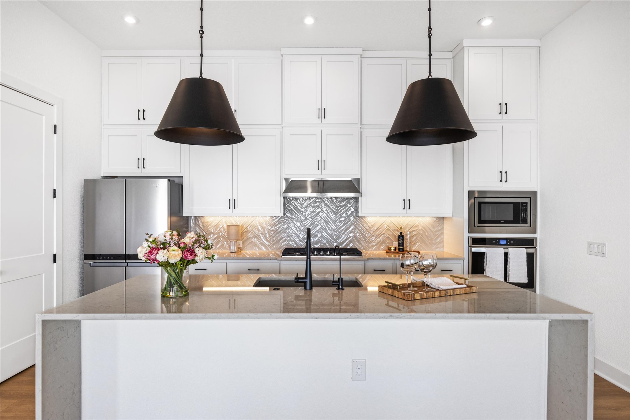 1122 Silver Dollar Trail Georgetown, TX 78628 - Photo 12 of 35 a kitchen with stainless steel appliances granite countertop a sink a stove and a wooden floors