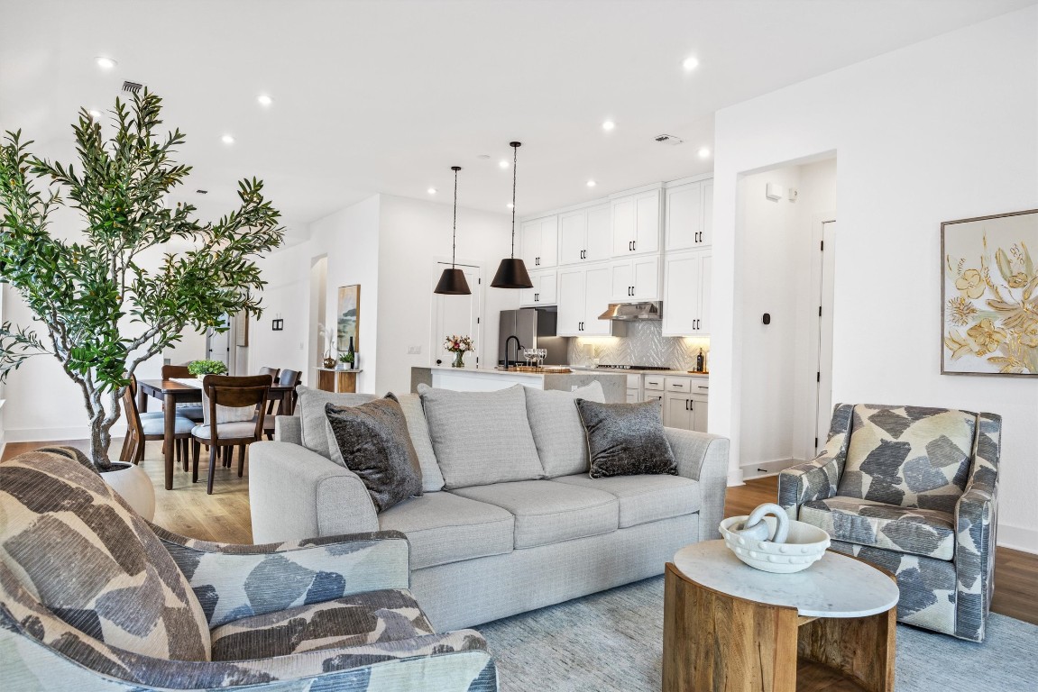 1122 Silver Dollar Trail Georgetown, TX 78628 - Photo 16 of 35 a living room with furniture kitchen and a potted plant
