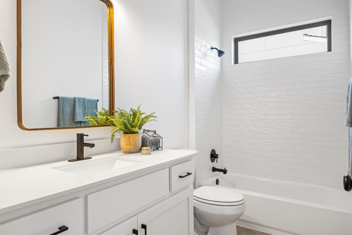 1122 Silver Dollar Trail Georgetown, TX 78628 - Photo 17 of 35 a bathroom with a sink a toilet and a mirror