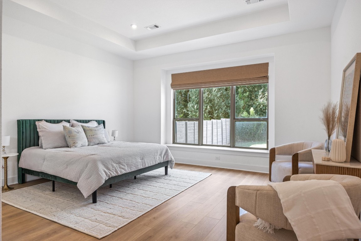 1122 Silver Dollar Trail Georgetown, TX 78628 - Photo 20 of 35 a spacious bedroom with a bed and glass window