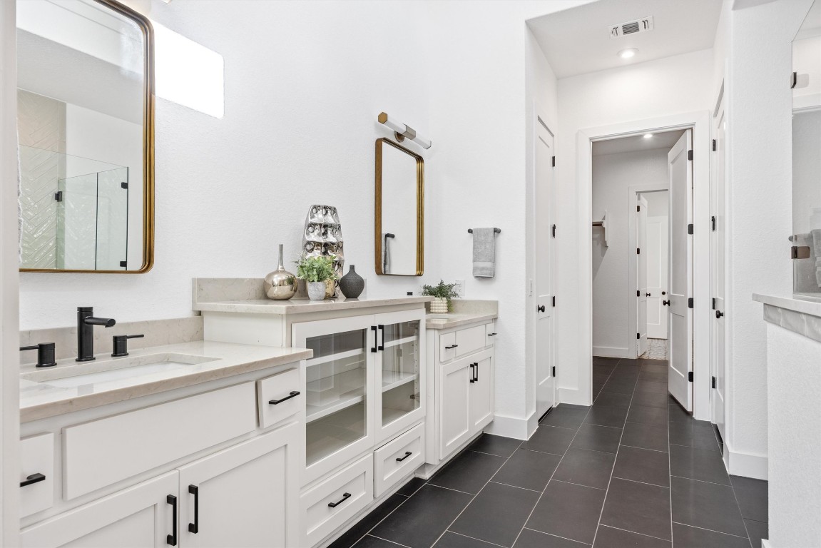 1122 Silver Dollar Trail Georgetown, TX 78628 - Photo 22 of 35 a bathroom with a double vanity sink mirror and