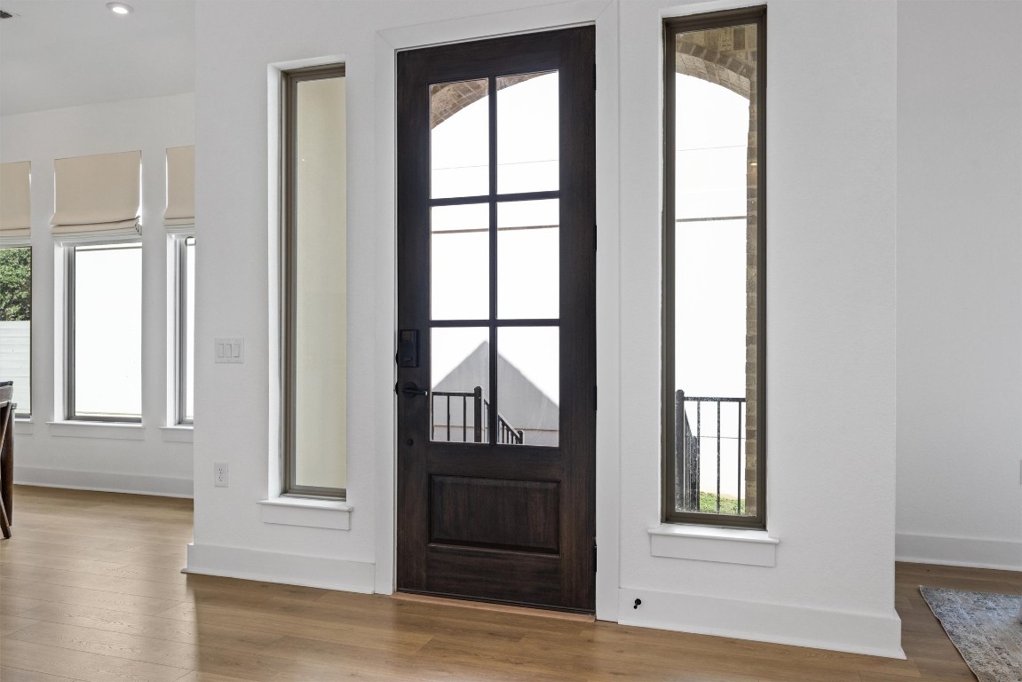 1122 Silver Dollar Trail Georgetown, TX 78628 - Photo 6 of 35 an empty room with wooden floor and windows