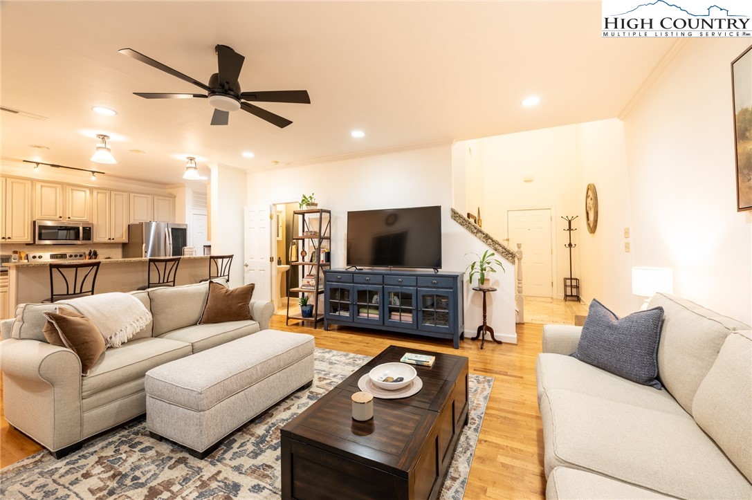 114 Charles Lowe Lane, Unit 19 Banner Elk, NC 28604 - Photo 12 of 38 a living room with furniture and a flat screen tv with kitchen view