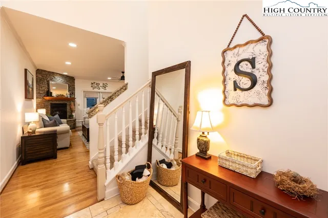 a view of entryway and hall with wooden floor