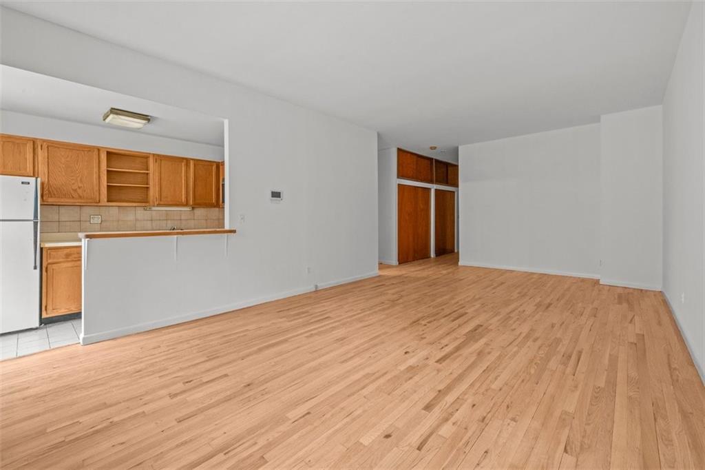 191 Clinton Street, Unit 2B Brooklyn, NY 11201 - Photo 1 of 10 a view of empty room with wooden floor and fan