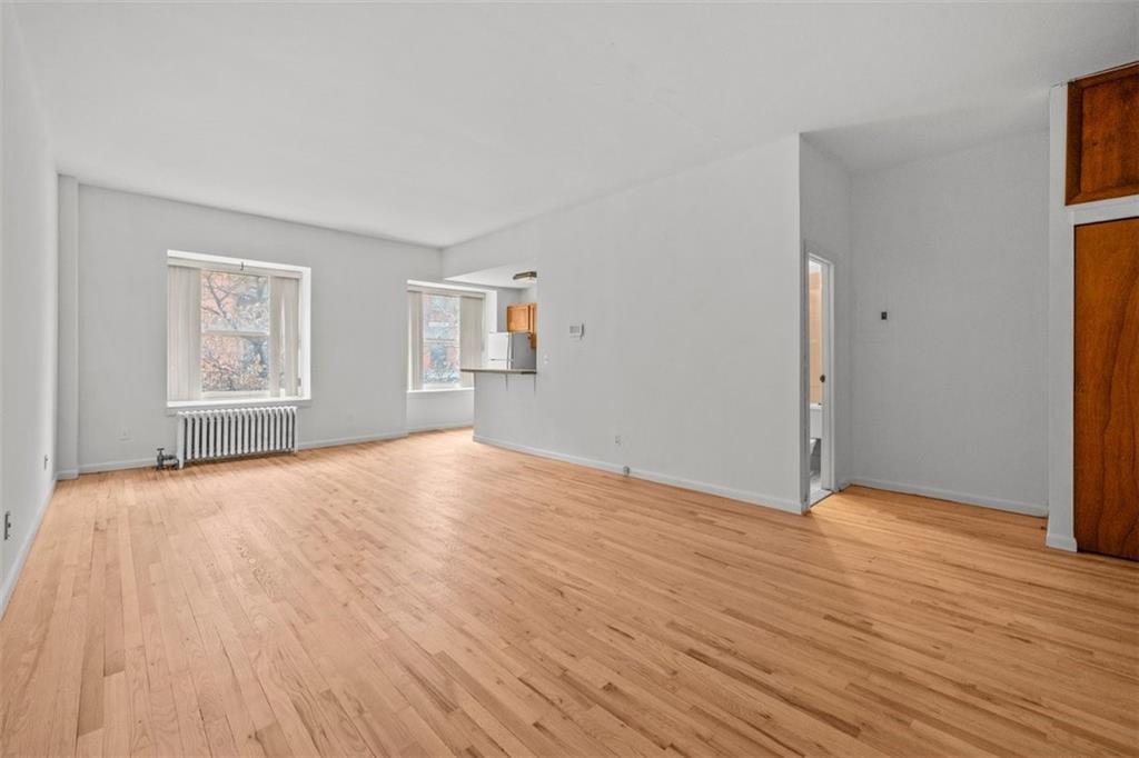 191 Clinton Street, Unit 2B Brooklyn, NY 11201 - Photo 2 of 10 a view of empty room with wooden floor and fan