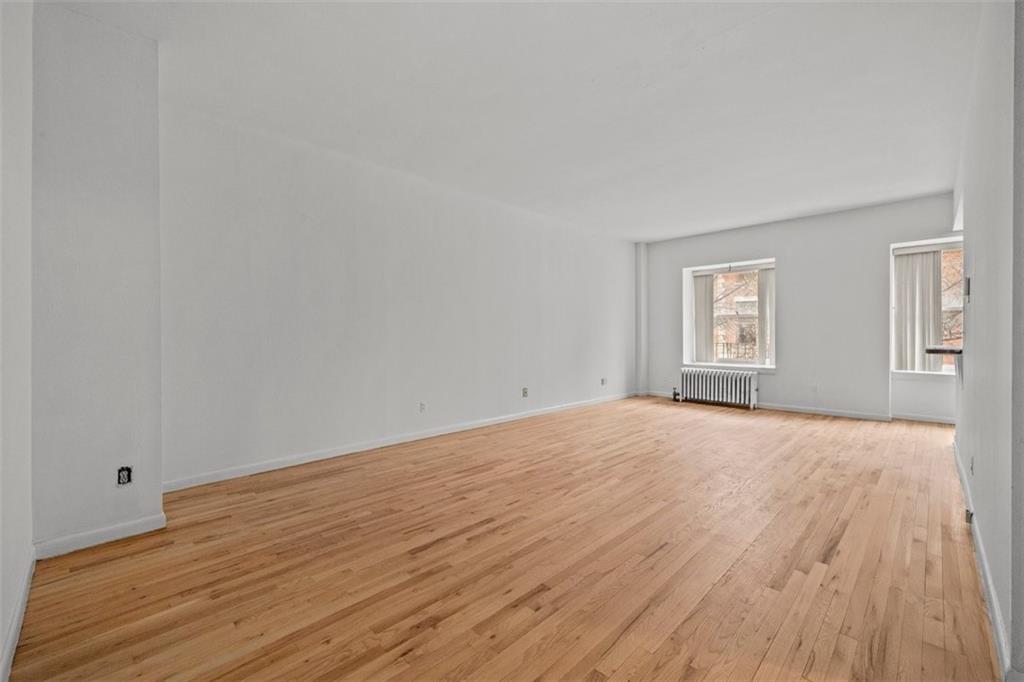 191 Clinton Street, Unit 2B Brooklyn, NY 11201 - Photo 3 of 10 a view of empty room with wooden floor and fan