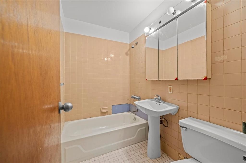 191 Clinton Street, Unit 2B Brooklyn, NY 11201 - Photo 5 of 10 a bathroom with a sink a toilet and shower