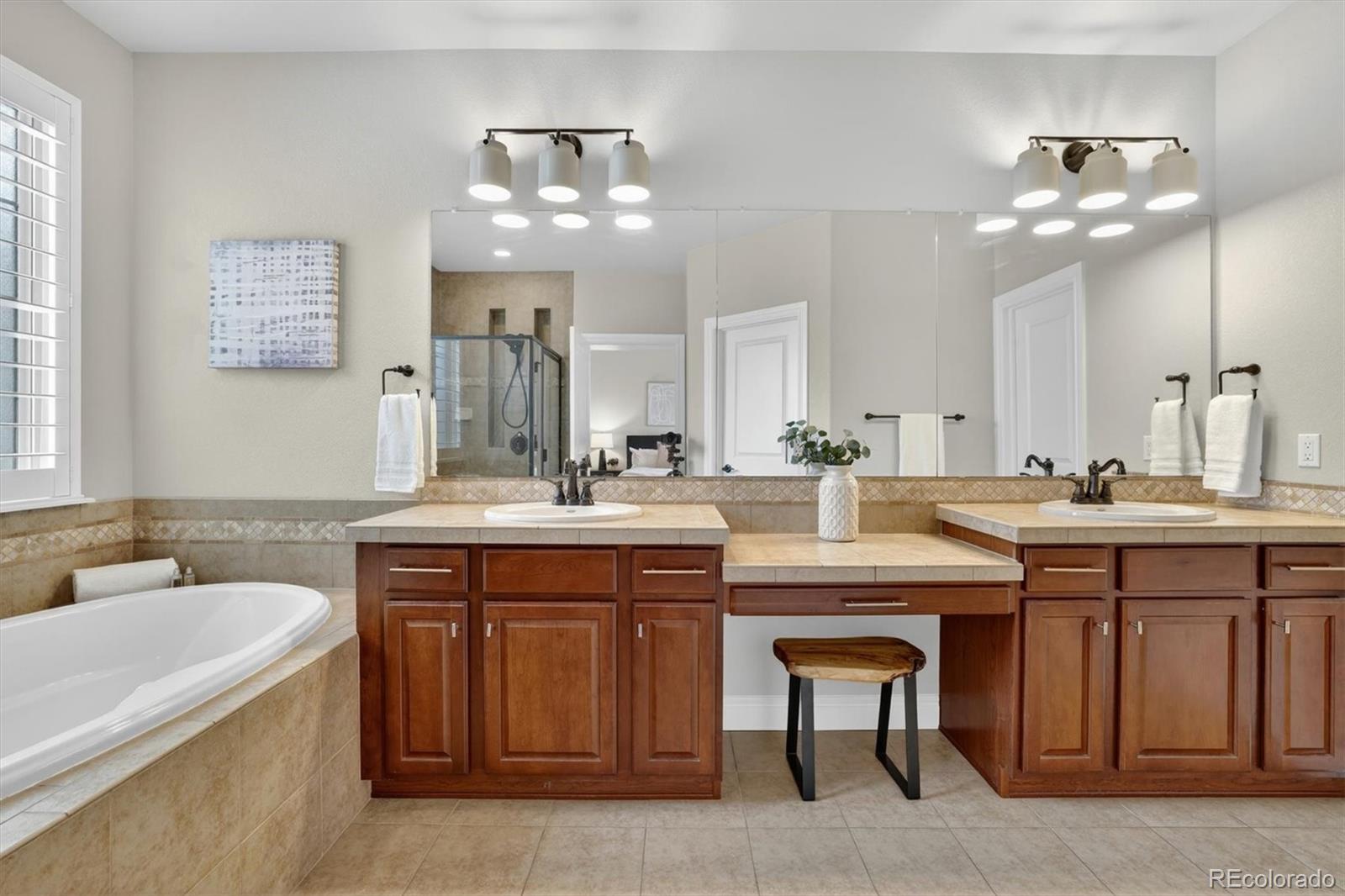 10126 RidgeGate Circle Lone Tree, CO 80124 - Photo 19 of 32 a bathroom with a sink double vanity and a mirror