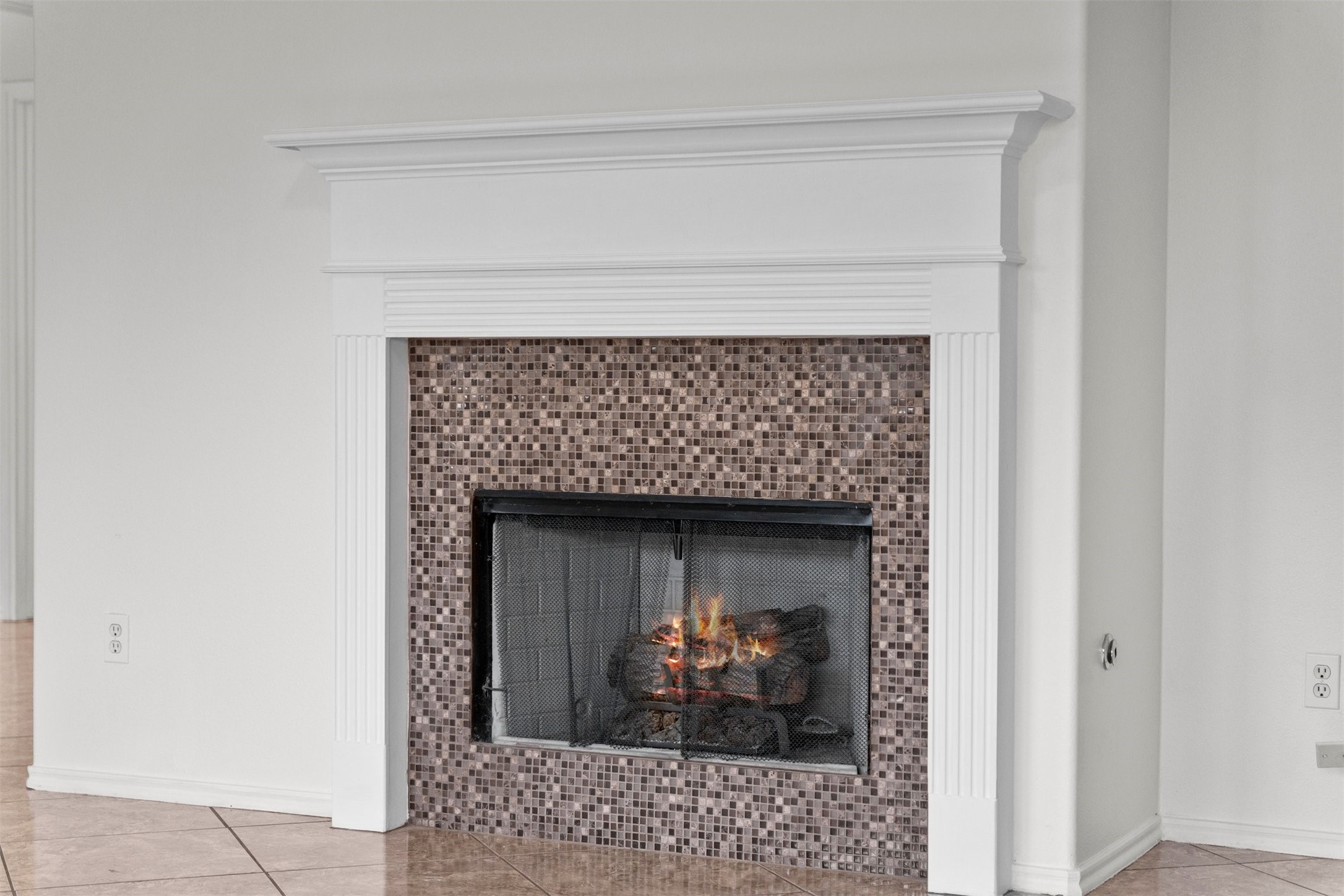 2507 Grayfeather Court Spring, TX 77388 - Photo 14 of 37 Cozy gas fireplace with a beautiful mosaic frame and mantle make this a showcase piece in the living area.