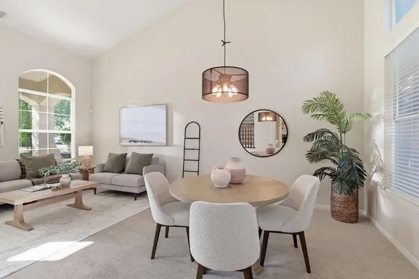 a view of a dining room with furniture wooden floor and chandelier