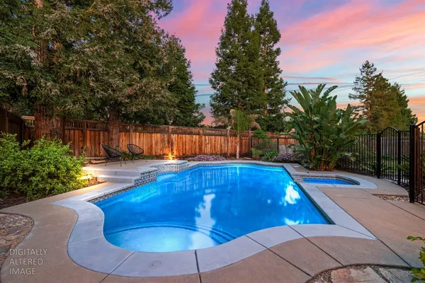 a view of a backyard with swimming pool