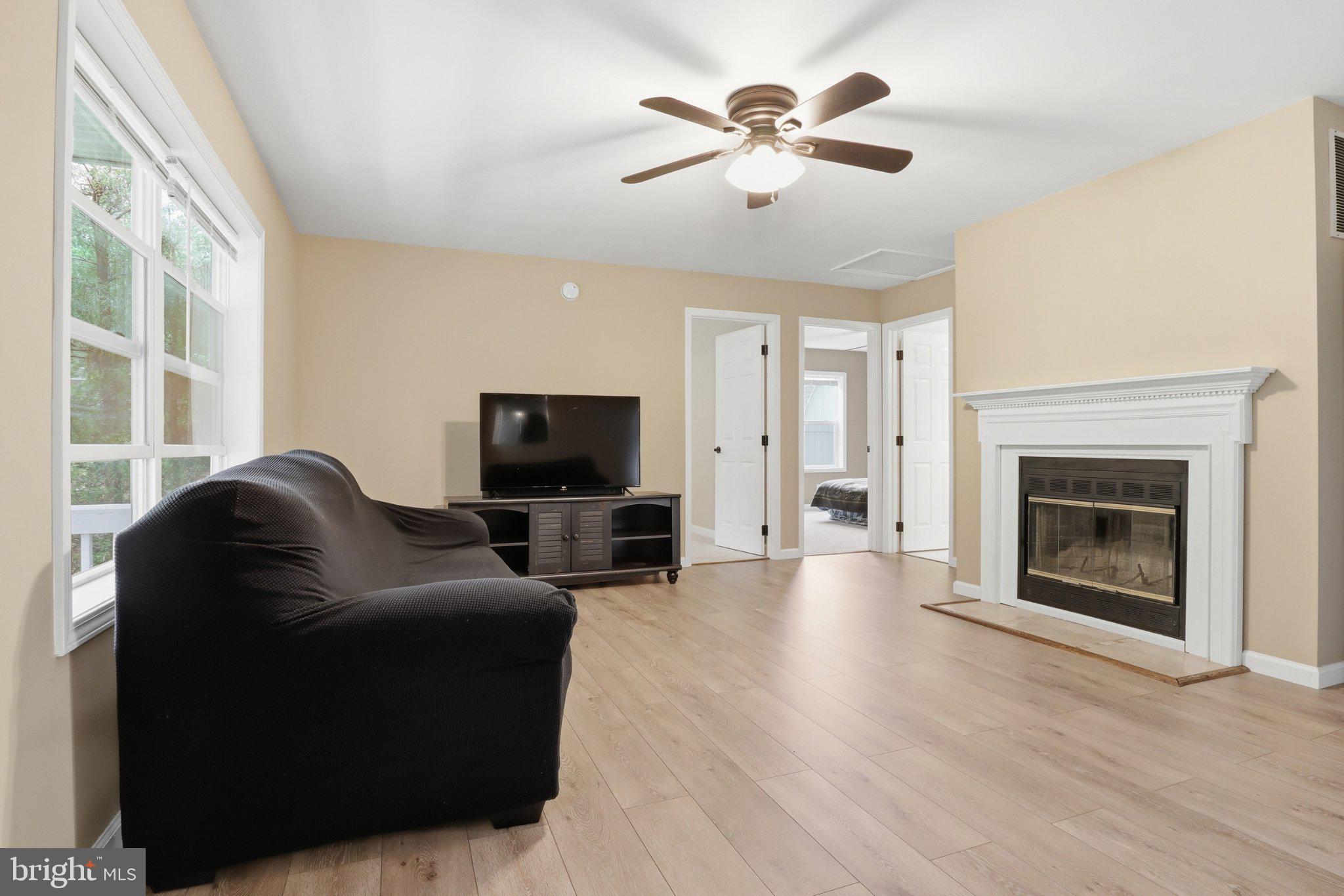491 Garvine Mill Road Fawn Grove, PA 17321 - Photo 5 of 47 a living room with furniture a fireplace and a flat screen tv