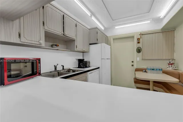 a kitchen with stainless steel appliances a stove a sink and a refrigerator