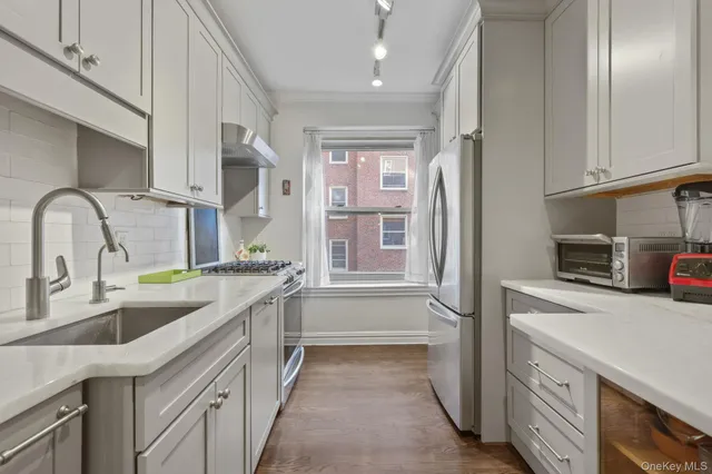 a kitchen with a sink and a refrigerator