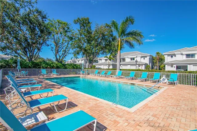 a view of a backyard with a patio and swimming pool