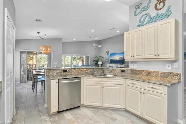 a kitchen with white cabinets stainless steel appliances and sink