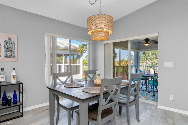 a view of a dining room with furniture wooden floor and chandelier