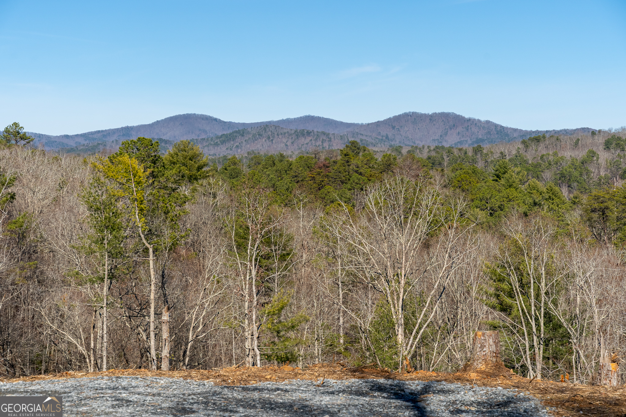 a view of a mountain with a mountain in the background