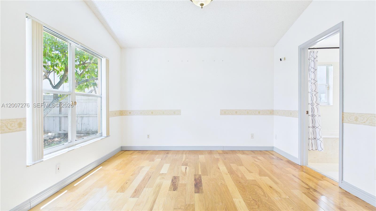 17626 Southwest 20th Street Miramar, FL 33029 - Photo 13 of 27 a view of empty room with wooden floor and fan