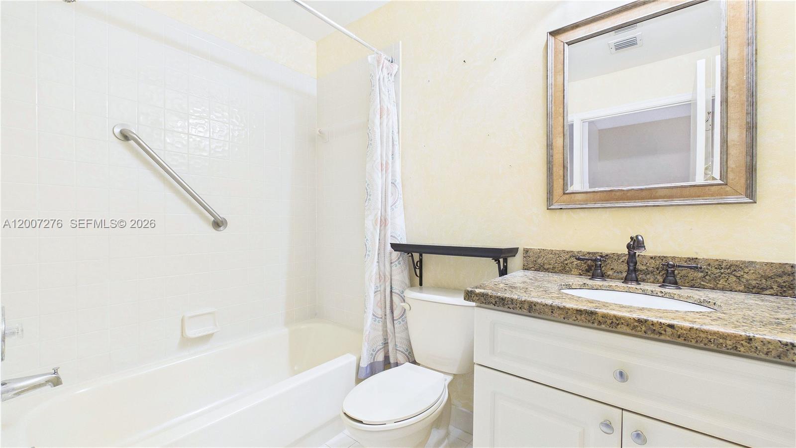 17626 Southwest 20th Street Miramar, FL 33029 - Photo 17 of 27 a bathroom with a granite countertop sink toilet and mirror