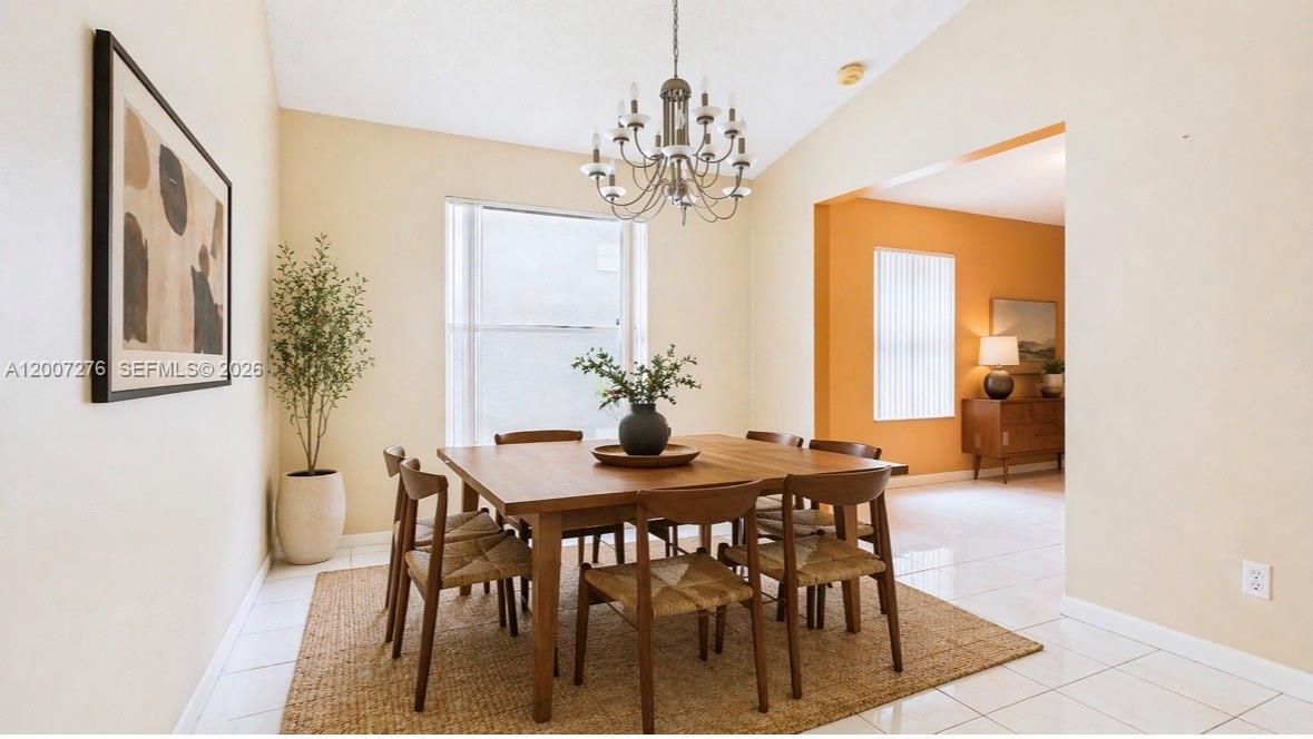 17626 Southwest 20th Street Miramar, FL 33029 - Photo 4 of 27 a view of a dining room with furniture and chandelier