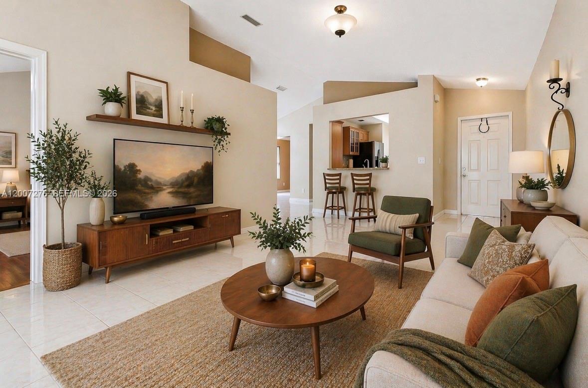 17626 Southwest 20th Street Miramar, FL 33029 - Photo 6 of 27 a living room with furniture and a flat screen tv