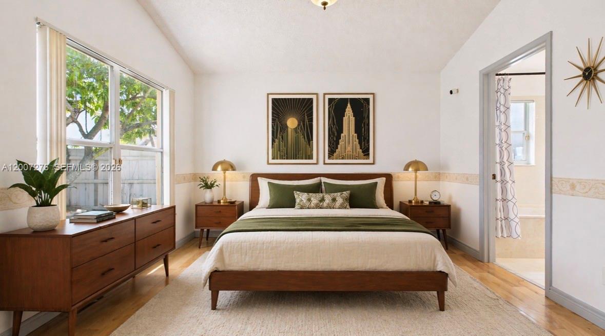 17626 Southwest 20th Street Miramar, FL 33029 - Photo 7 of 27 a bedroom with a bed table flowerpot and window