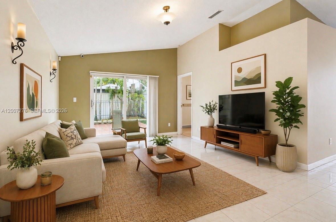 17626 Southwest 20th Street Miramar, FL 33029 - Photo 8 of 27 a living room with furniture a flat screen tv and a large window