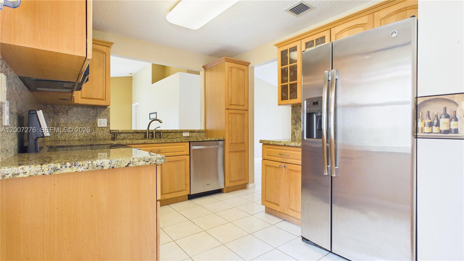 17626 Southwest 20th Street Miramar, FL 33029 - Photo 9 of 27 a kitchen with a refrigerator and a sink
