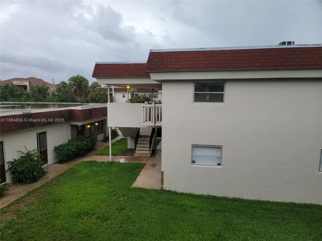 a backyard of a house with table and chairs