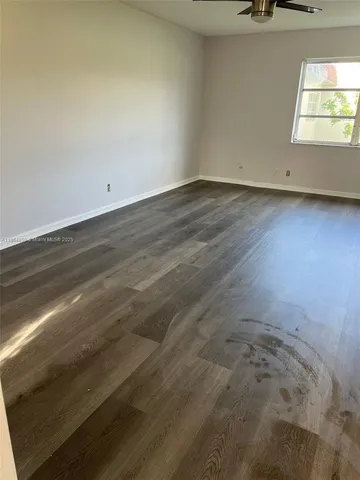 a view of an empty room and a window