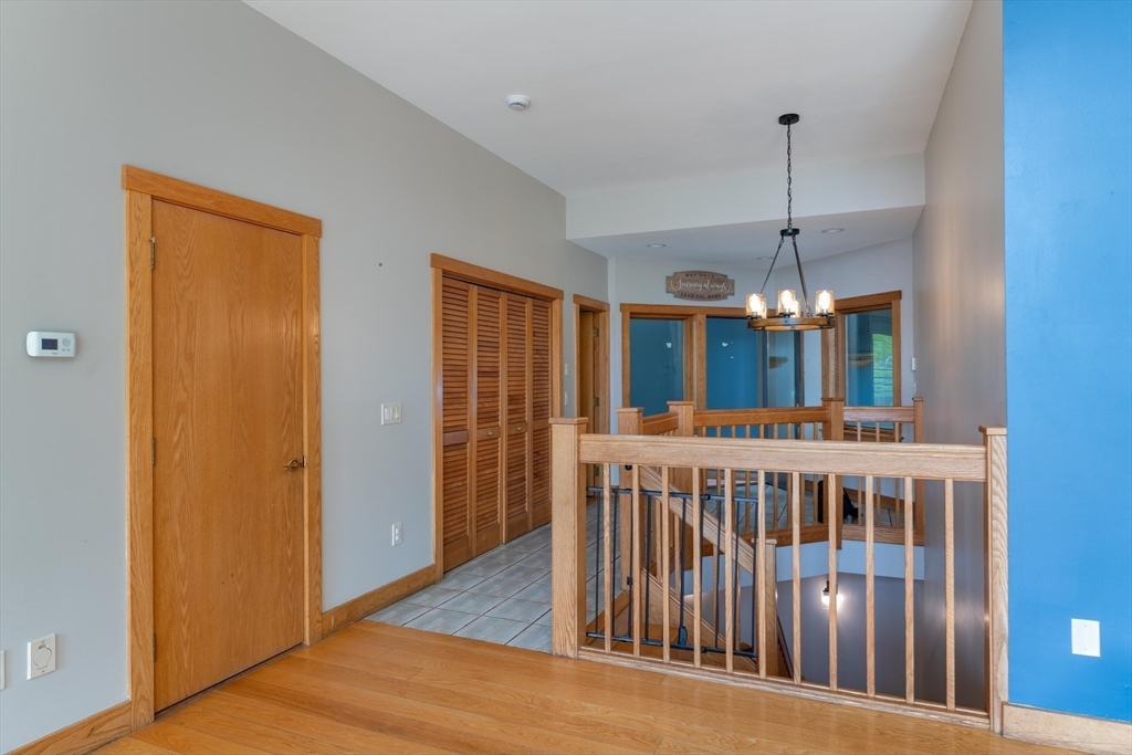 184 W Road Bernardston, MA 01337 - Photo 30 of 41 a view of a room with windows wooden floor and chandelier