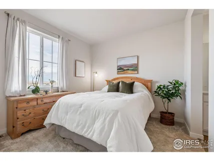 a bedroom with a bed and a potted plant
