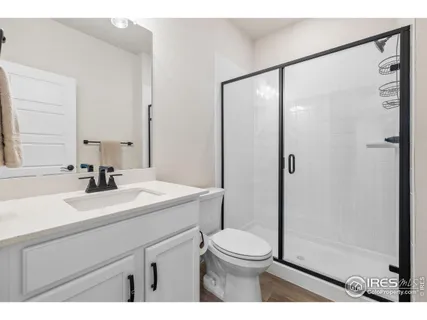 a bathroom with a sink mirror vanity and toilet