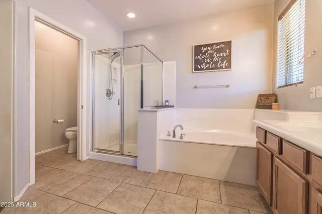 a bathroom with a tub a sink and a shower