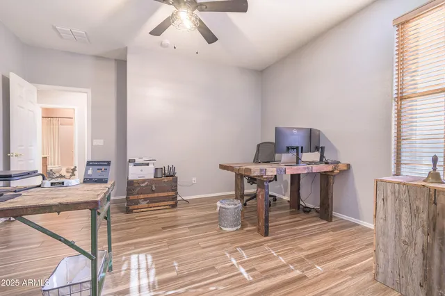 a view of a workspace with furniture and a window