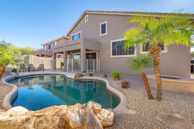 a view of a house with pool and sitting area