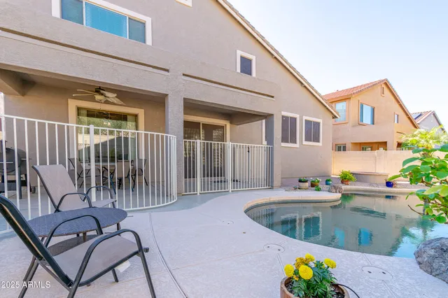 a view of a house with backyard and sitting area