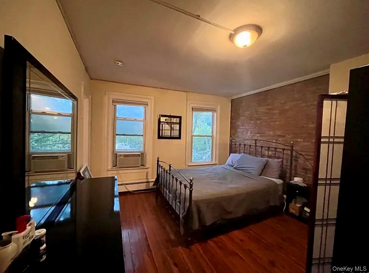 118 Main Street, Unit 3 Nyack, NY 10960 - Photo 1 of 20 a bedroom with a bed next to a window with wooden floor