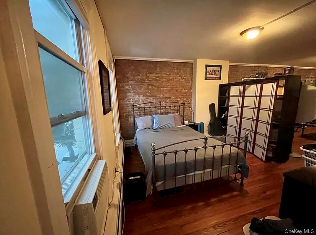 118 Main Street, Unit 3 Nyack, NY 10960 - Photo 11 of 20 a bedroom with a bed and wooden floor