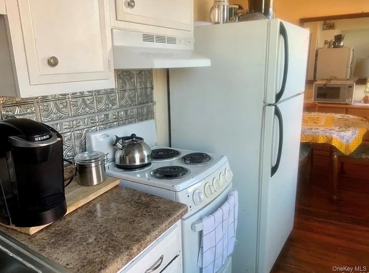 118 Main Street, Unit 3 Nyack, NY 10960 - Photo 3 of 20 a kitchen with a stove and a refrigerator